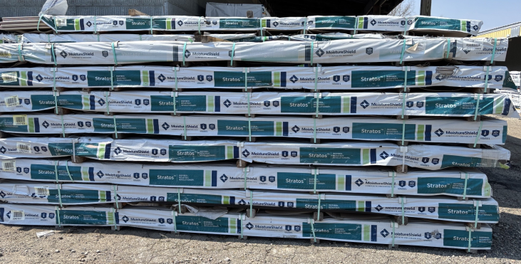 MoistureShield Stratos composite decking bundles stacked in contractor yard